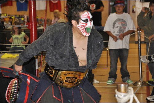 The Great Kasaki taunts fans at ringside.