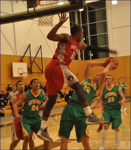 A Holy Cross player gets some mad hops blocking a Lynden player.