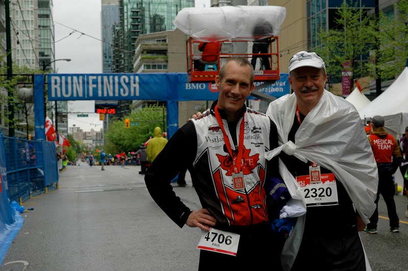 Rick Cooney, right, with his good friend and fellow marathon runner Paul Wright at the finish line of last Sunday’s BMO Vancouver Marathon.