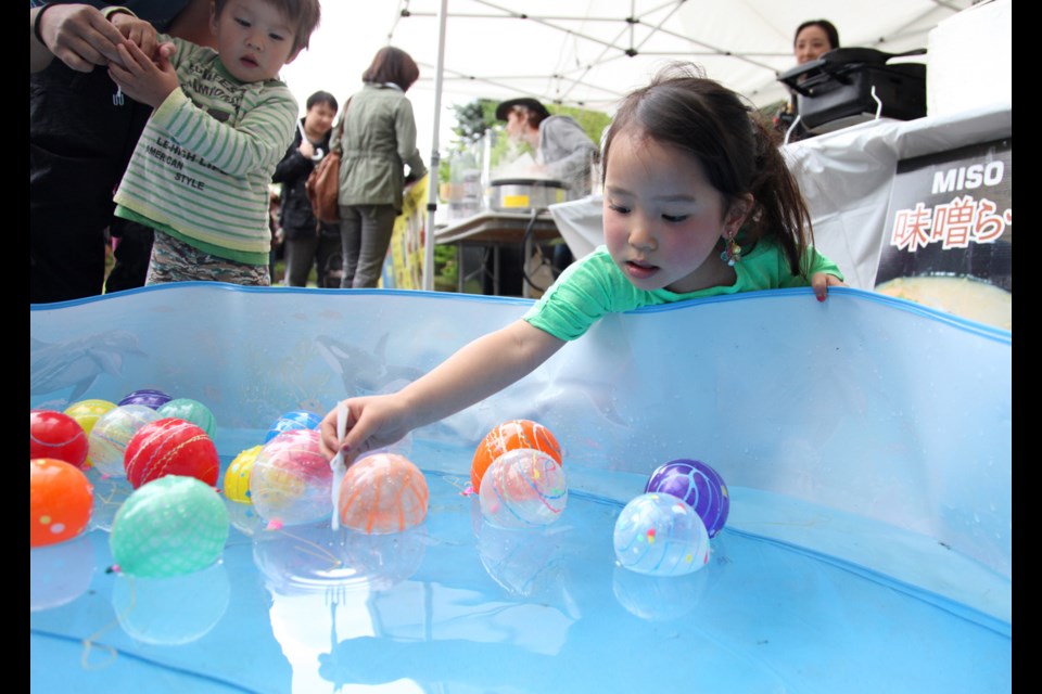 Hannah Aoyama fishing for balloons at the Japan Kids festival at the Nikkei Centre.