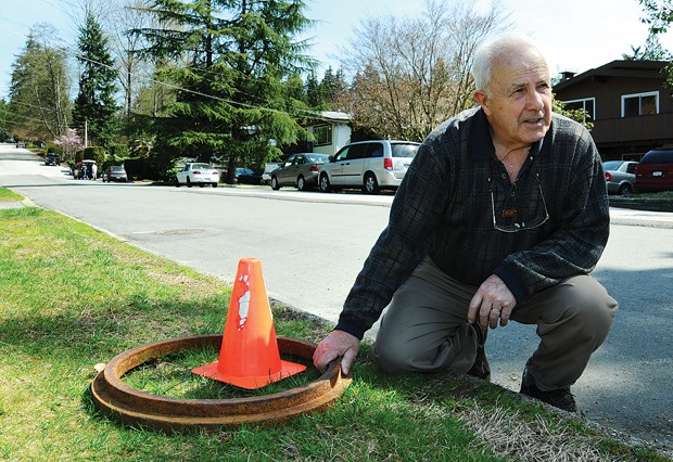 Ted Winram, a Westover Road resident, shows where a damaging water main break happened in 2012.