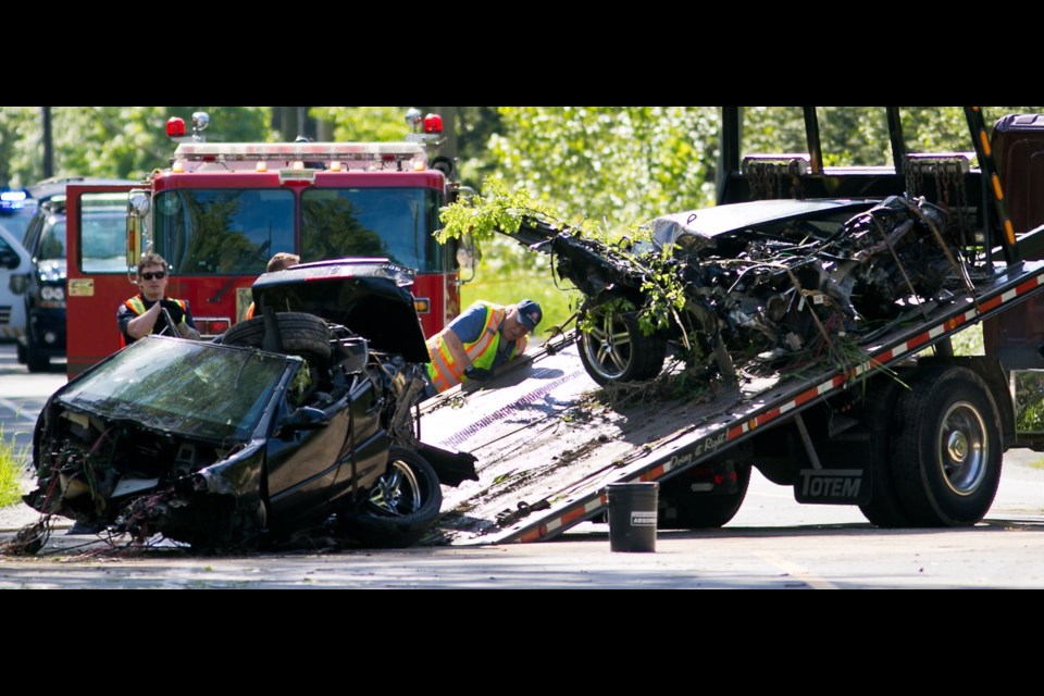 Monday: A wrecked car is loaded onto flatbed truck on West Saanich Road near Hartland Road.