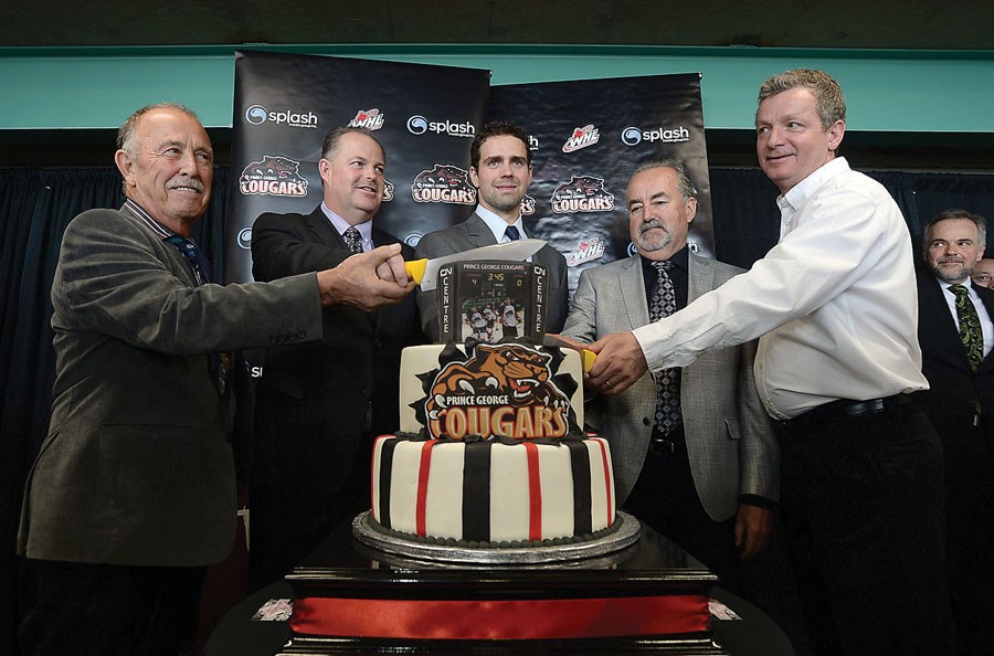 The new ownership group left to right Ray Fortier, Greg Pocock, Dan Hamhuis, John Pateman and Ernest Ouelett cutting the cake. Citizen photo by Brent Braaten May 13 2014