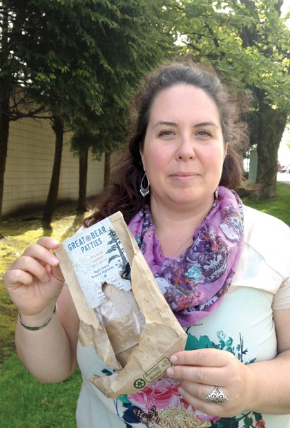 Tracy Lydiatt holds the crumpled wrapper of her "Great Bear Patties," all that remains after a bear broke into her car in West Vancouver Saturday night.