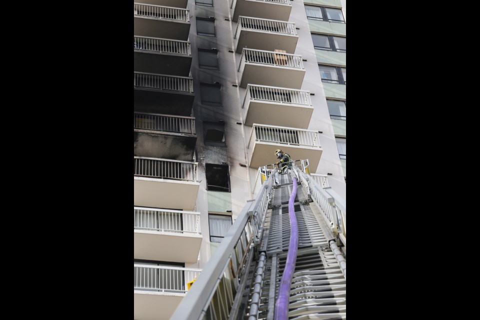 Firefighters and police respond to a fire on the ninth floor of View Towers apartments in Victoria on May 15, 2014.