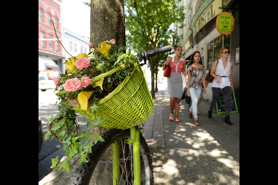 Yes, they’re real and they’re spectacular! Flowers adorn a bicycle parked on Cambie street near Hastings Street. Photo Dan Toulgoet