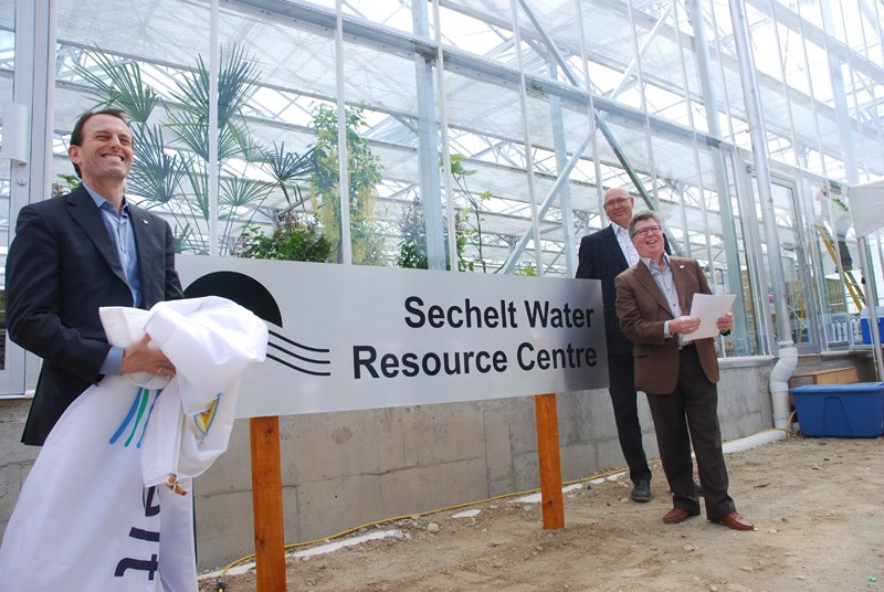 West Vancouver - Sunshine Coast - Sea to Sky Country member of Parliament John Weston, left, Sechelt Mayor John Henderson, right, and Mike Reinders, president of Maple Reinders, unveil a sign with the name of Sechelt’s new wastewater treatment facility during a dedication event on Wednesday, May 21. See more photos and video from the event on our website at www.coastreporter.net