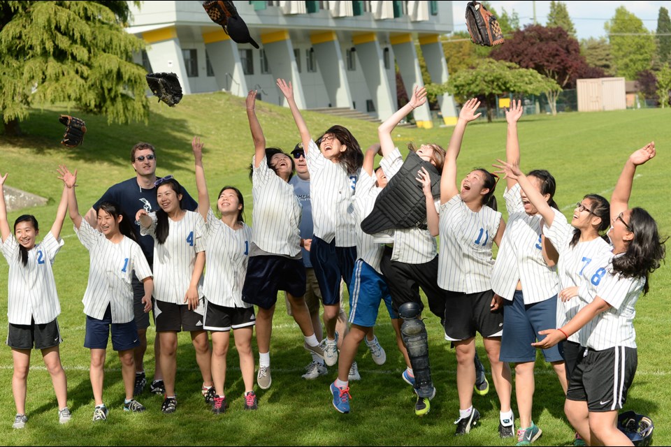 The Thompson Trojans celebrate their 9-8 semifinal win over the Churchill Bulldogs on May 21, 2014.