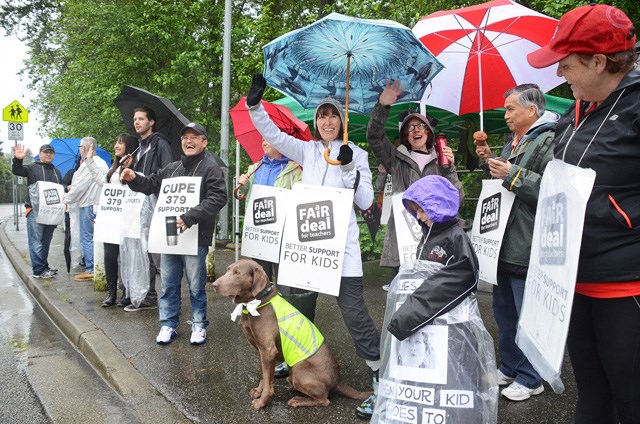 Burnaby Mountain Secondary teachers and CUPE employees picket their school as part of province-wide rotating teacher strikes Thursday.