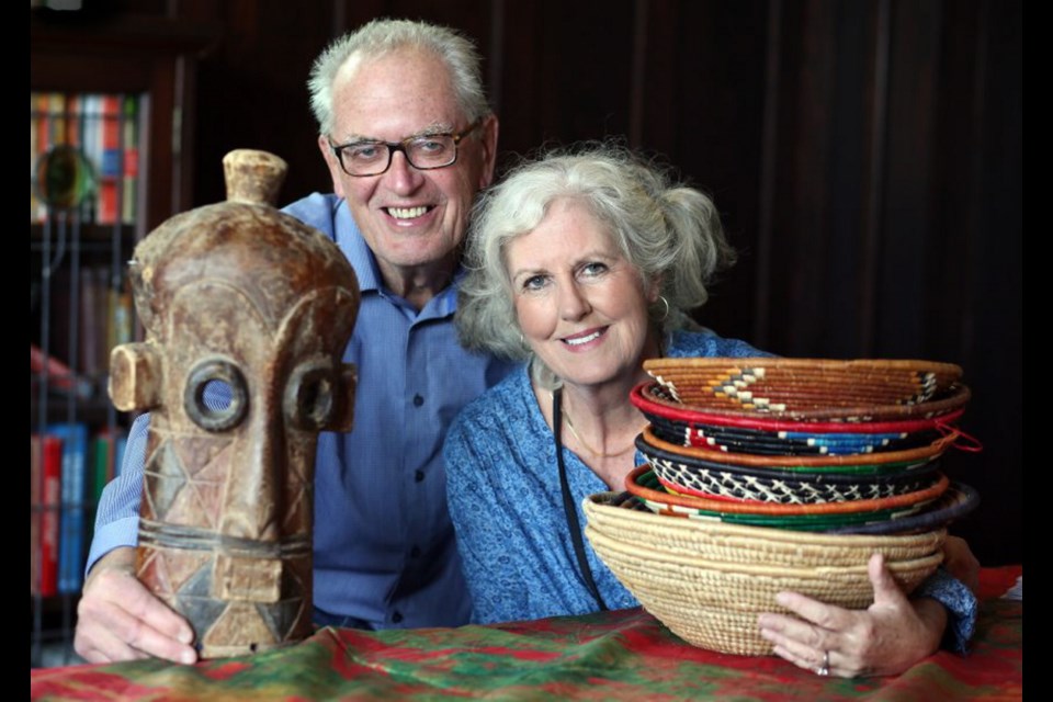 Dr. Jim Sparling and his wife Martha Menzies with some of the items for sale at their African Evening fundraiser, with speaker Robert Bateman.