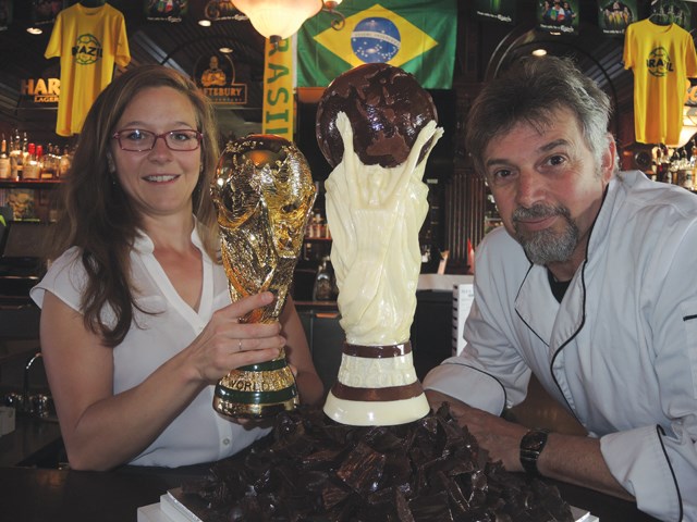 Chocolatier Dominique Jarry with his World Cup of chocolate and Buck & Ear manager Gennesse Langdon. The chocolate World Cup will be cracked open by Rick Hansen after the final on Sunday, with everyone in the pub getting a piece.