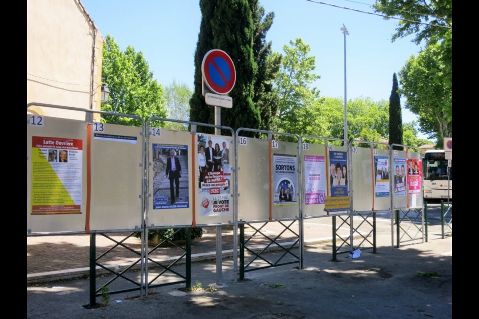 In France, each candidate is allocated an equal amount of space to affix political campaign posters. Photo Michael Geller