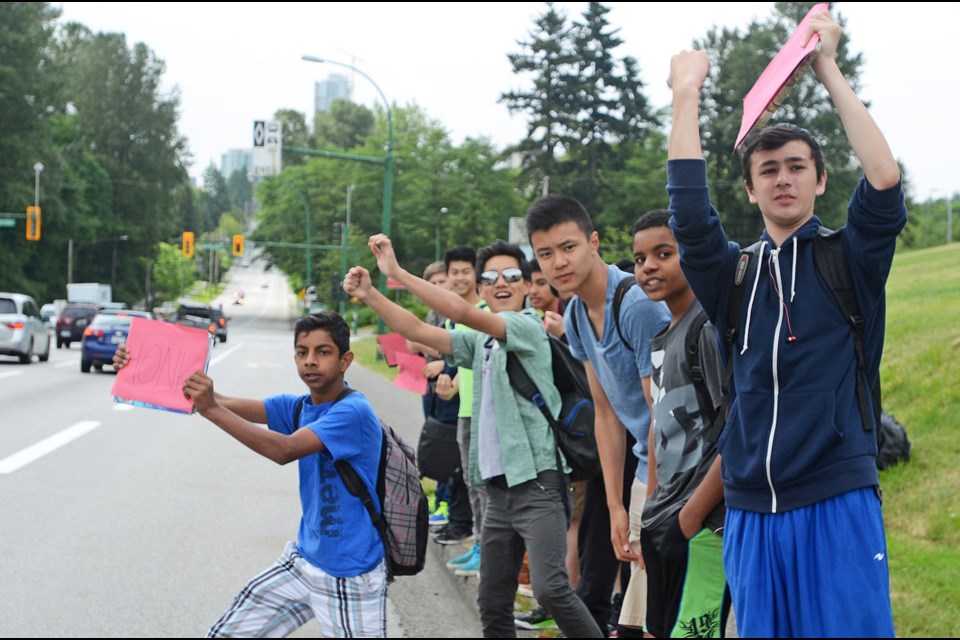 Students protest in front of Moscrop Secondary Wednesday against the labour dispute between the B.C. Teachers' Federation and the provincial government.