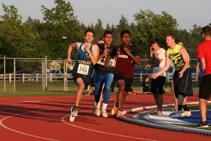 Chatelech runner Alex Nightingale, left, sprints past other runners during the boys 4x400m relay at last week’s B.C. High School Track and Field Championships in Langley. See more photos in our online galleries at www.coastreporter.net.