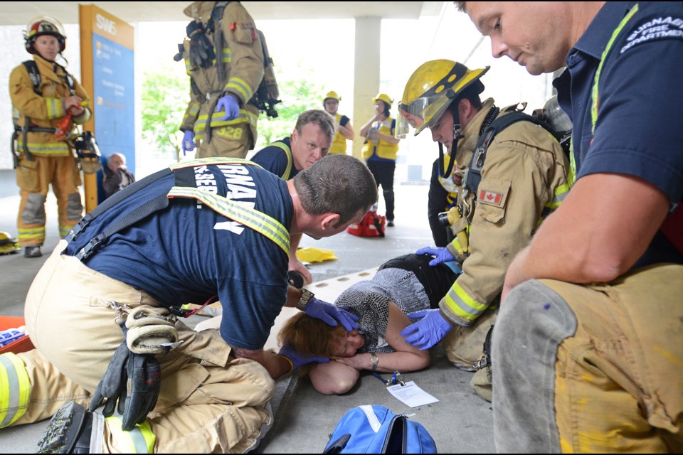 Burnaby firefighters assess a “victim” during a disaster-preparedenss exercise at BCIT's Burnaby campus Wednesday.