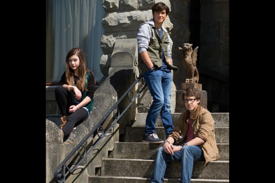Keean Johnson, centre, with co-stars Katie Douglas and Nick Purcha outside Victoria's Craigdarroch Castle, which doubles as Shadowmire, Spooksville's spooky hilltop mansion.