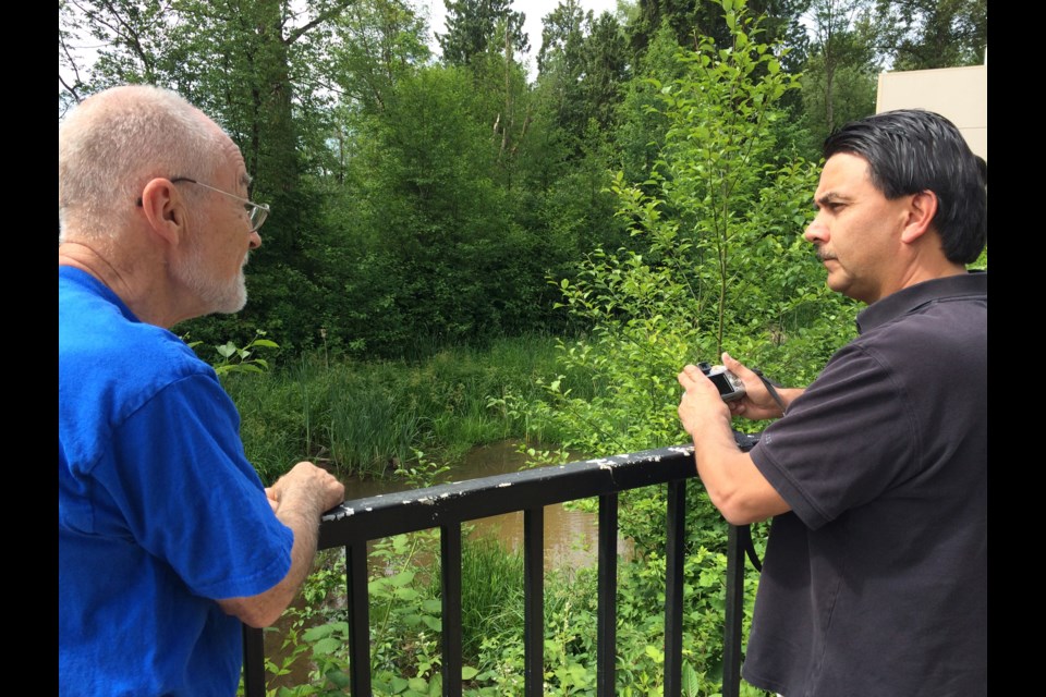 Streamkeepers Alan James and John Preissl want CN to fix this murky pond on Silver Creek.