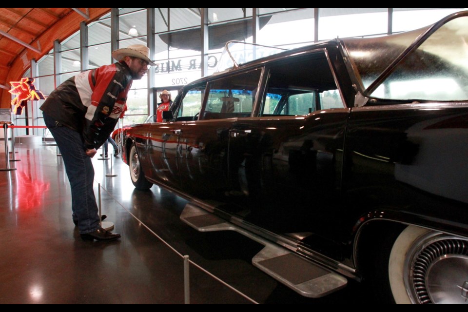 Mark McNeely gets a closer look at the 21-foot 1964 Lincoln Continental limousine.