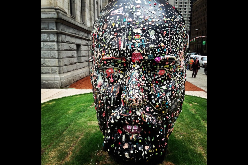 Passersby can stick their used chewing gum anywhere on Douglas Coupland's giant head as part of the Vancouver Art Gallery's exhibition Douglas Coupland: everywhere is anywhere is anything is everything.