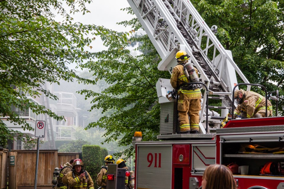 A rooftop fire closed down part of August Avenue on Tuesday as Burnaby firefighters fought the blaze.