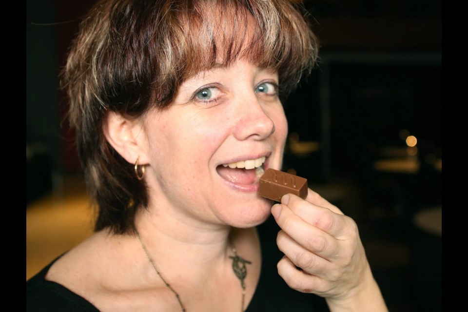 Julie Briere from Julie's Delights prepares to sink her teeth into a chocolatey morsel at the celebration of confectionary put on at the Royal B.C. Museum. The chocolates she makes are filled with such spicy ingredients as ginger, cayenne pepper and lemon.