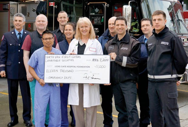 Lions Gate Hospital emergency department staff David Damian, Sherri Stackhouse and Angeline Bierstee accept an $11,000 cheque from Dave DiSpirito of North Vancouver City Fire Department and his team. The North Vancouver Firefighters Charitable Societies raised the money at their Park & Tilford Christmas lights display. It will go towards supporting a special procedures cart in the resuscitation room.