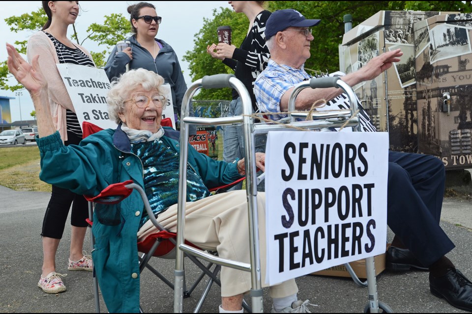 Retired teachers Betty Griffin and James Turner join Edmonds Community School teachers on the picket line Monday.