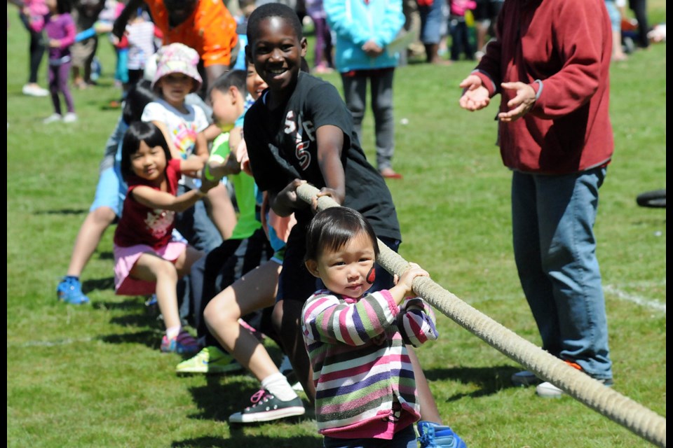 Natalie Leng, 2, jumps in to help out in the tug o' war at the first Family Festival held in Burnaby Central Park on Sat June 21.