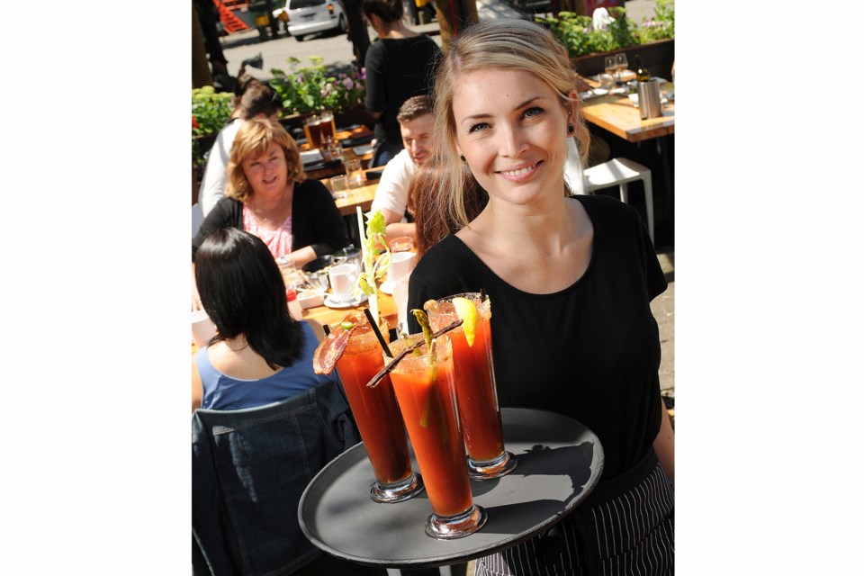 Edible Canada server Camille Thomas shows off three new cocktails added to the bistro's new summer caesar menu just in time for Canada Day. Photo Dan Toulgoet