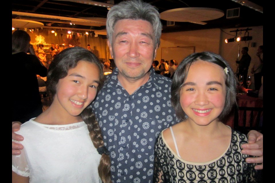 Adil Bestybayev accompanied his daughter, Meruert, left, and Adaryn Ko on the piano for a special concert in support of the Sarah McLachlan School of Music.