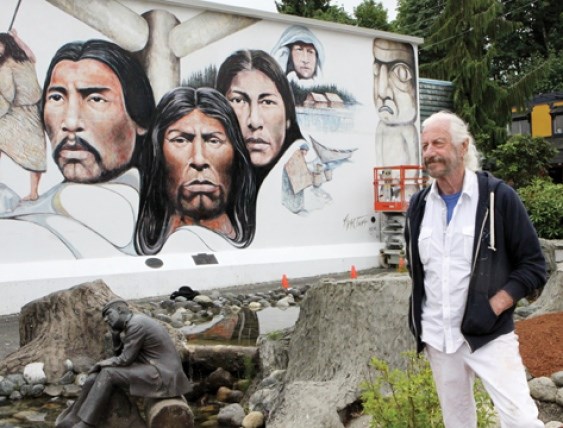 Artist Paul Ygartua, who has been restoring his mural in Chemainus.