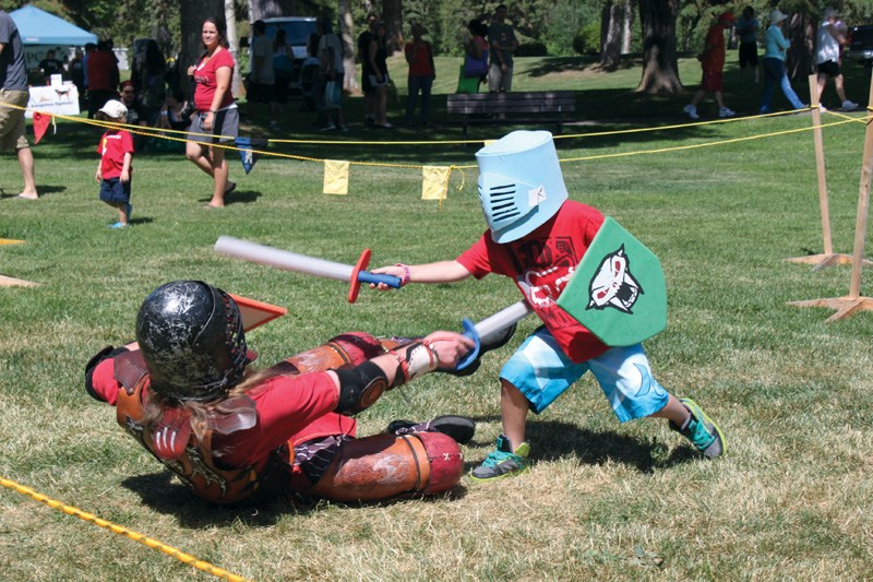 Justin Neurauter, 6, takes down Markus - a.k.a. Jeff Betke - of the Shrine of Cold Keep at Fort George Park on Tuesday.
