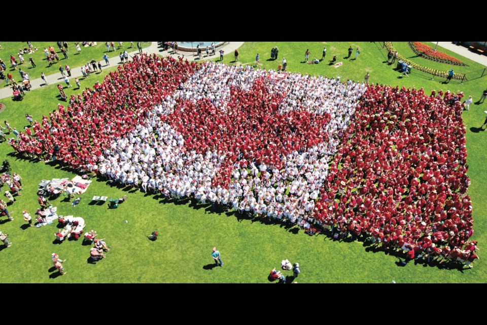The Living Flag, formed by people dressed in red and white, on the lawn of the B.C. legislature.