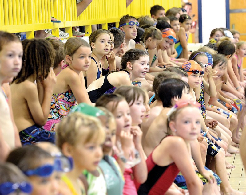 Young triathletes waiting to start in Four Seasons pool.