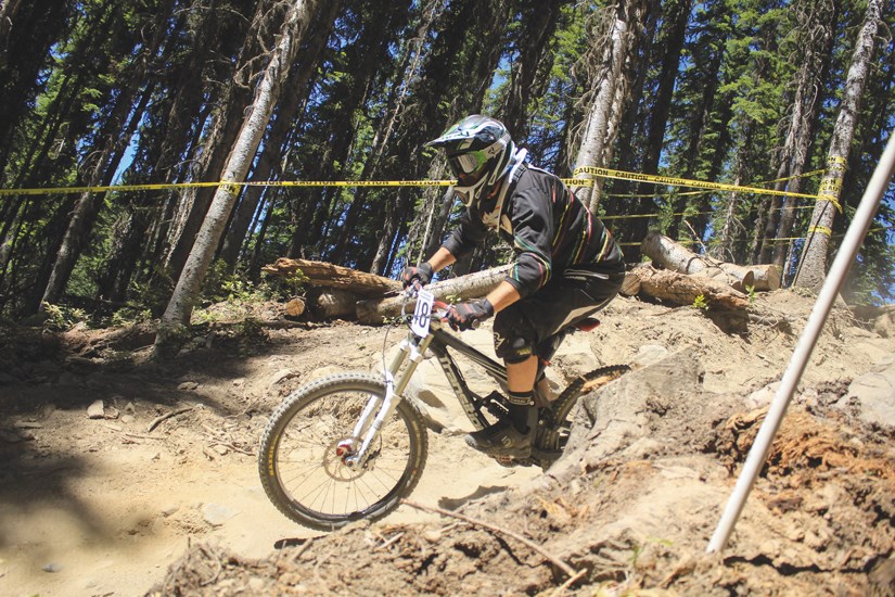 North Vancouver's Michael Mooney picks up speed on his way to a gold medal win in the master men's 50+ category at the 2014 Canadian Mountain Bike Championships held Sunday at Sun Peaks Resort in Kamloops. North Shore riders won three national titles at the event.