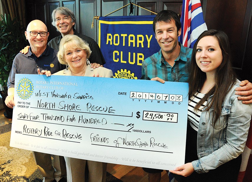 Robert Crozier and Karen Harrison of the Rotary Club of West Vancouver Sunrise donate a $24,500 cheque to Bruce Moffat, Mike Danks and Taylor Jones, representing North Shore Rescue. The funds were raised at the Rotary Ride for Rescue in memory of late NSR team leader Tim Jones.