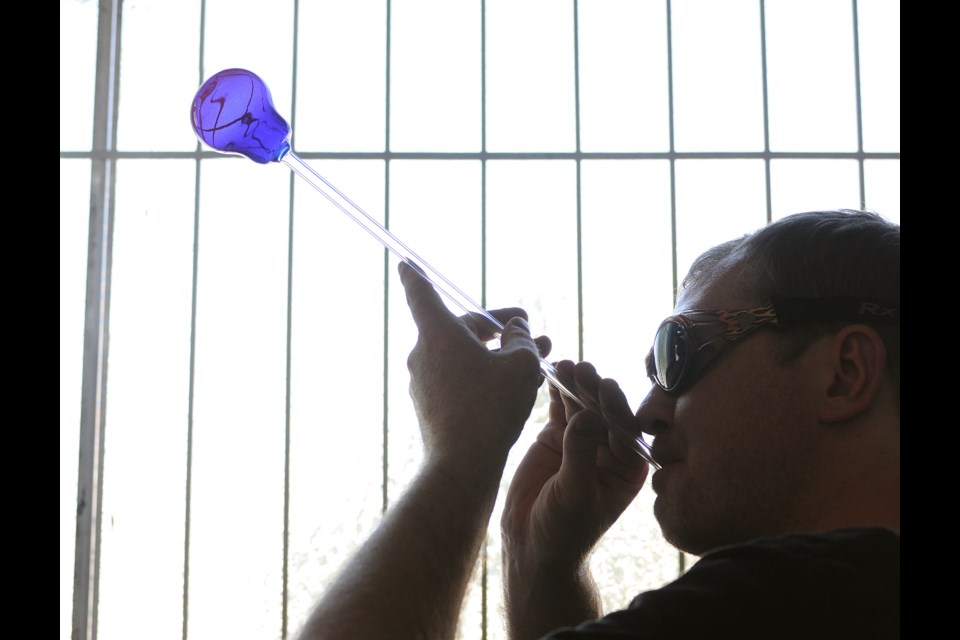 Glass artist Braden Hammond, 34, at work in his East Vancouver Frances Street studio. photo Dan Toulgoet