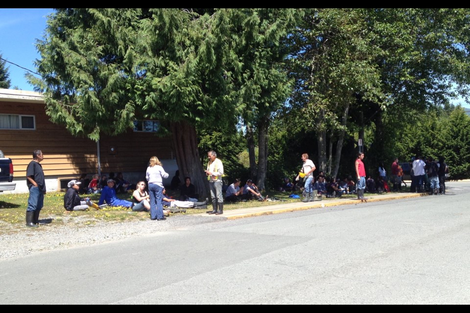 Workers and tourists evacuated from downtown Ucluelet following a late morning ammonia leak at Ucluelet Harbour Seafoods wait at the corner of Peninsula and Bay streets for the all-clear in the noon hour on Wednesday, July 30, 2014.