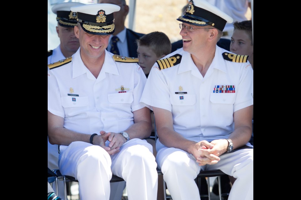 Outgoing base commander Commodore Luc Cassivi, left, and new base commander Capt. Steve Waddell listen to speeches during a Canadian Forces Base Esquimalt Change of Command ceremony at the CFB Esquimalt Naval and Military Museum Wednesday.