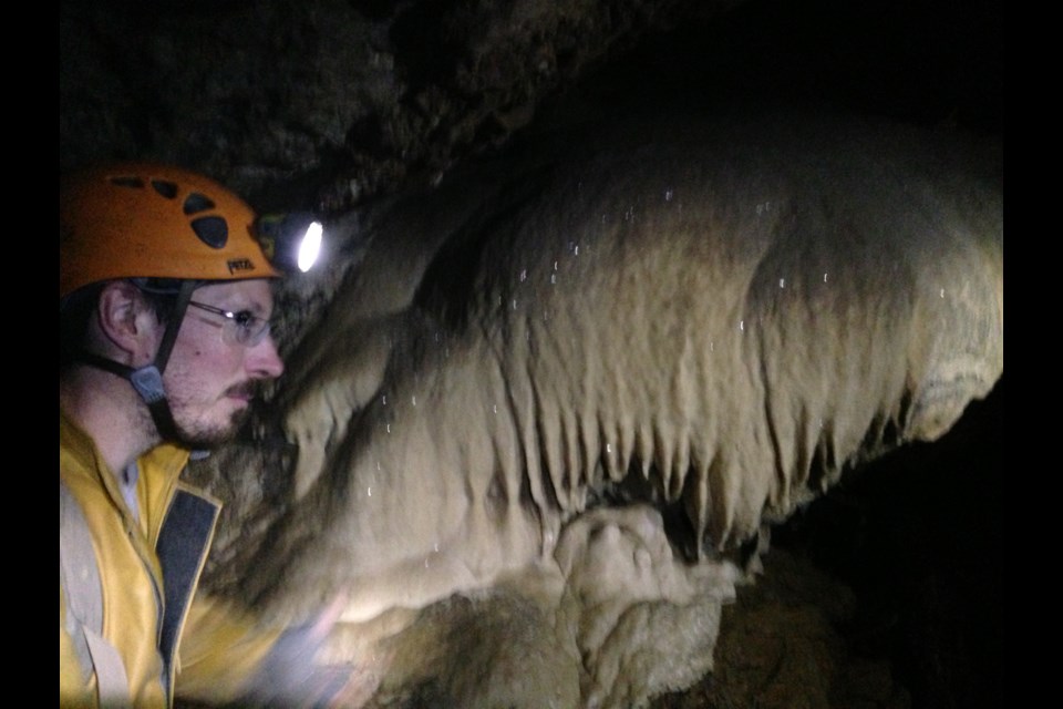 Paul Blood explains calcite formation in the Riverbend Cave. Photo: Andrew Fleming
