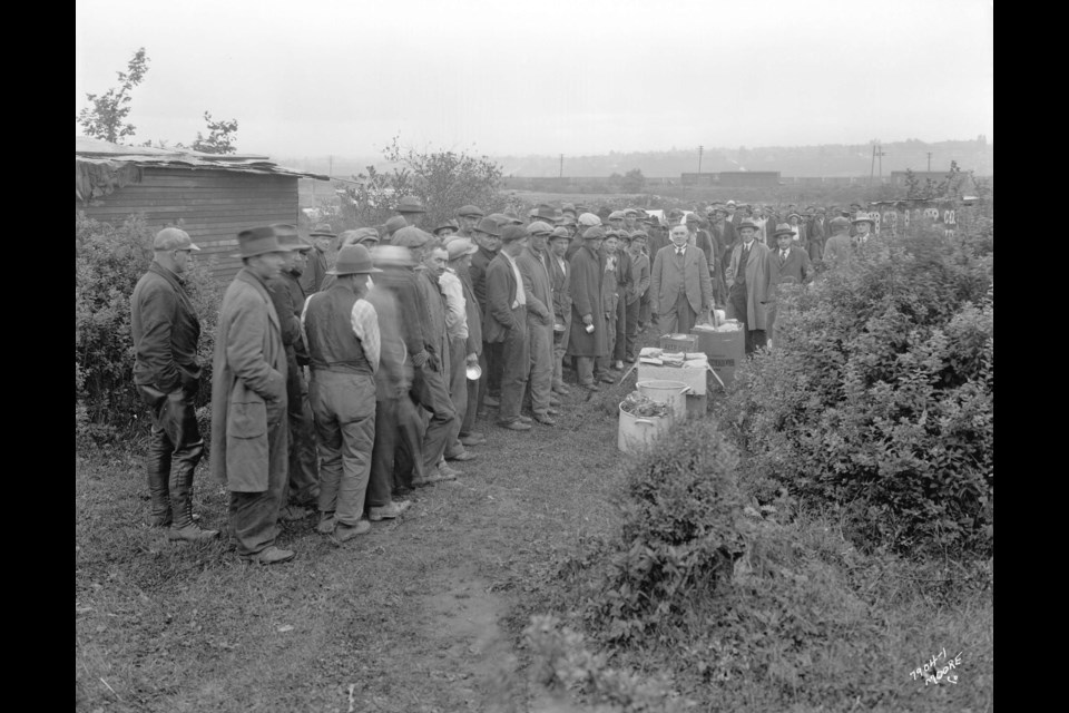 Men line up for a distribution of food by the First United Church at the City Dump in 1931