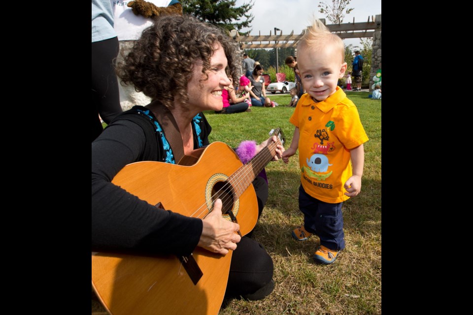 Eighteen-month-old Logan Matheson, who weighed just one pound and 10 ounces when he was born, listens to entertainer Susan Seale at the 30th reunion of Victoria General Hospital's Neonatal Intensive Care Unit on Aug. 14, 2014.