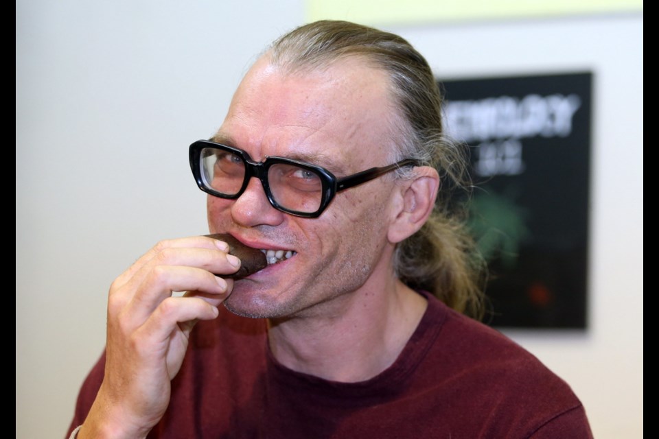 Ted Smith, the founder the Victoria Cannabis Buyers Club, bites into a double chocolate marijuana cookie.