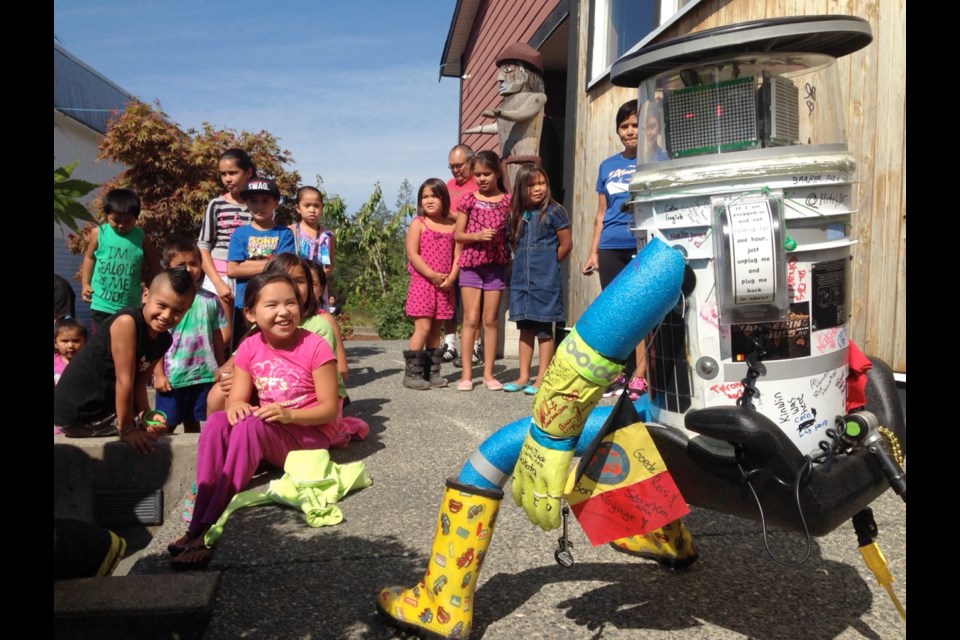 HitchBOT had a welcome party outside the Pauquachin nation band office Monday.