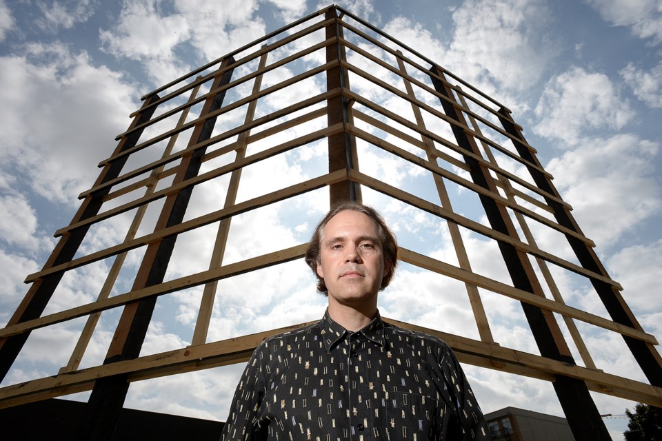 Stephen Bohus, a spokesman for the Residents' Association of Mount Pleasant, stands in front of a structure at Kingsway and Broadway that used to feature an advertising sign for The Independent development project. The advertisement violated the city's sign bylaw, so it had to be removed. Photo Jennifer Gauthier