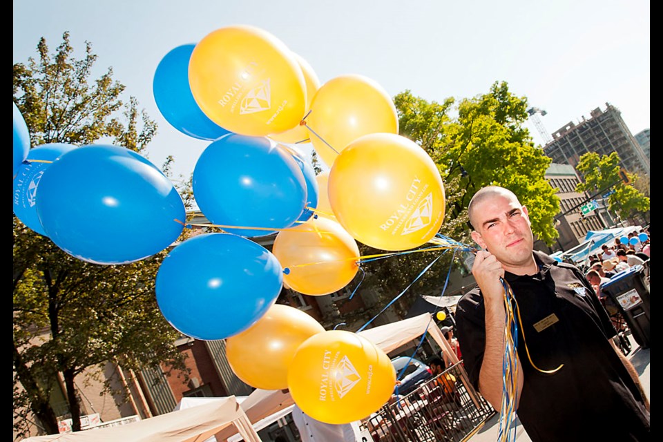 082314 - New Westminster, BC
Chung Chow photo
Columbia StrEAT Food Truck Festival closed Columbia Street on Saturday with more than 50 food trucks delighting eager palates. Corey Woolbett from Royal City Jewellers handing out balloons