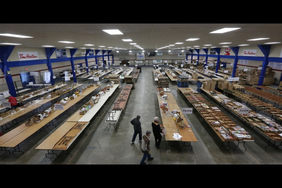 Volunteers organize rows of tables at the Victoria Curling Club, preparing for the annual Times Colonist Book Sale on May 4 and 5. Donations for the sale are being accepted Saturday and Sunday.