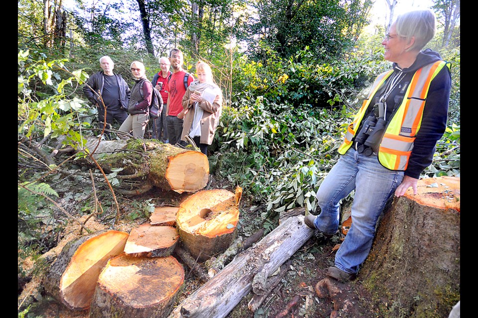 Christine Ensing, the city's environmental services officer, chats with a group of concerned citizens at the site where Kinder Morgan cut several trees. Ensing and a few other city staff members were standing watch over the are, ready to enforce city bylaws if Kinder Morgan returned.
