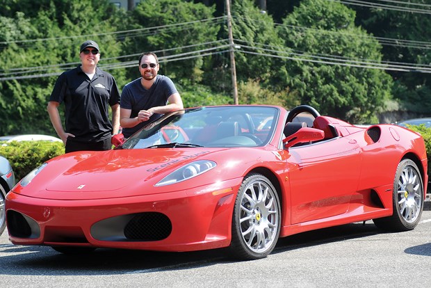 Thom Boeker of Scenic Rush and outwardly cool, inwardly terrified North Shore News columnist Andy Prest pose beside the $295,000 Ferrari F430 Spider that Prest is about to take for a spin.