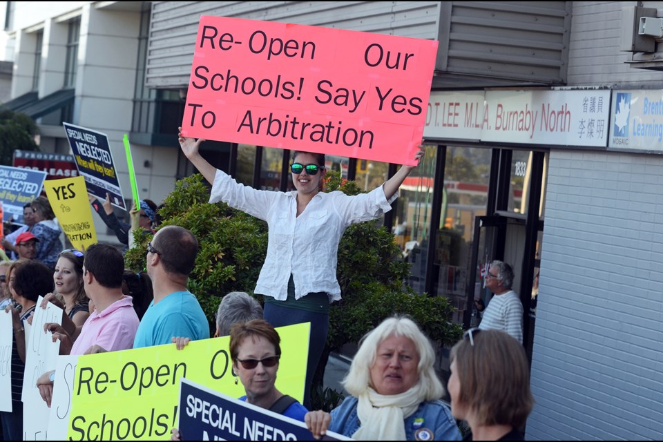 Local teachers rallied at Burnaby North Liberal MLA Richard Lee's office Monday afternoon, calling on the Liberal government to accept binding arbitration with the B.C. Teachers' Union to end the labour dispute that has kept schools closed this year.